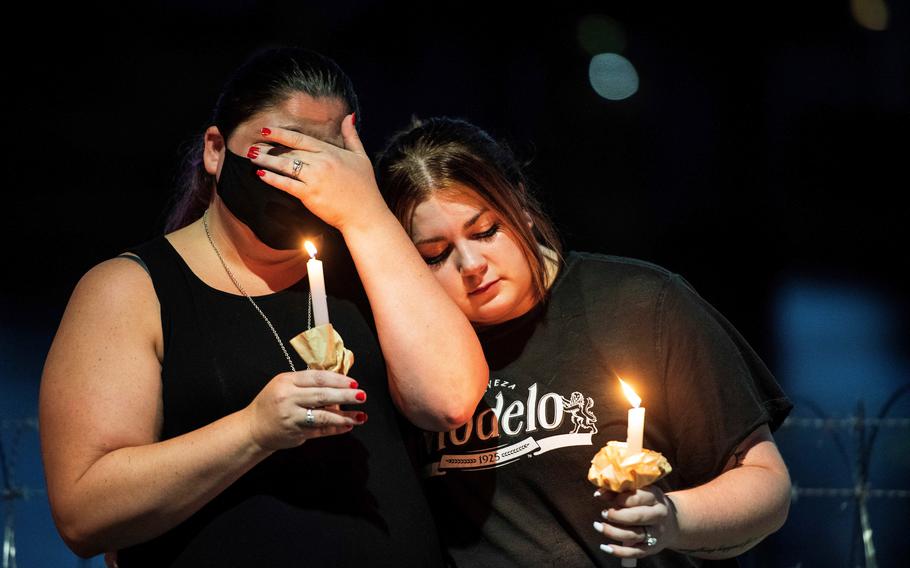 People gather at Marine Corps Air Station Iwakuni, Japan, Friday, Aug. 27, 2021, to honor 13 U.S. troops killed the previous day in a suicide attack outside Hamid Karzai International Airport in Afghanistan. 