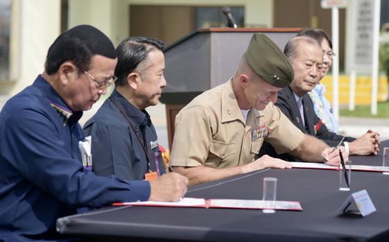 From left, Mayor Hajime Nakama of Kin and vice mayor Akira Nakamatsu of Chatan, Marine Maj. Gen. Stephen Liszewski of Camp Butler, Mayor Masanori Matsugawa of Ginowan and vice mayor Chiemi Oshiro of Urasoe sign a disaster preparedness agreement at Camp Foster, Okinawa, Nov. 7, 2022.