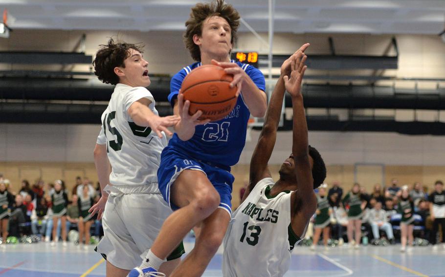 Rota’s Tyler DeMeritt gets between Naples’ Jettyn Jones, left, and Chris White in the Division II championship game at the DODEA-Europe basketball finals in Ramstein, Germany, Feb. 18, 2023. Naples beat Rota 46-25 to take the division title.