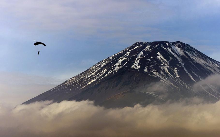 A U.S. Marine parachutes over a training area near Mount Fuji in Japan, Dec. 11, 2023.