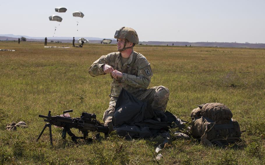 Army Pfc. Oluf Christensen gathers his parachute at Vaziani Training Area, Georgia, on Aug. 23, 2023, during Exercise Agile Spirit.