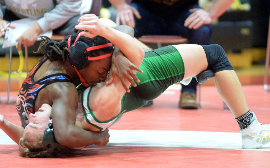 Humphreys' Matthew Nubin pins Kubasaki's Brady Potter at 145 pounds. Potter's second-place finish gave the Dragons just enough points to edge Kadena for the Division I team title.