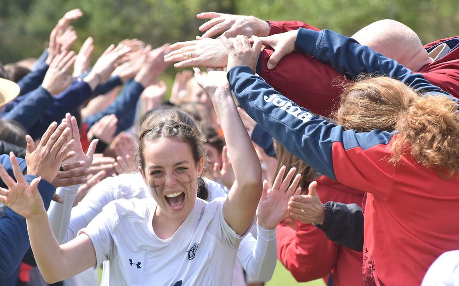 Lakenheath players run through a tunnel formed by players from the boys team and fans after advancing to the DODEA-Europe Division I girls championship game with a victory over Ramstein on Wednesday, May 17, 2023.