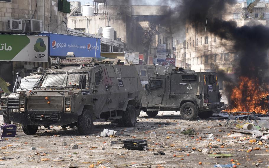 Smoke from fires fills the air as Palestinians clash with Israeli forces in the West Bank city of Nablus, Wednesday, Feb. 22, 2023.