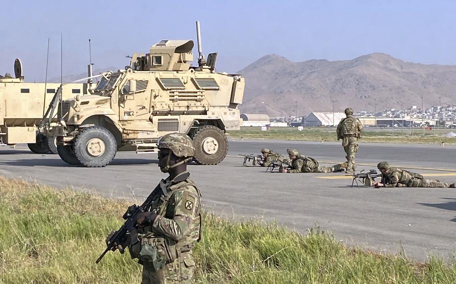 U.S troops stand guard along a perimeter at the international airport in Kabul, Afghanistan, Monday, Aug. 16, 2021. 