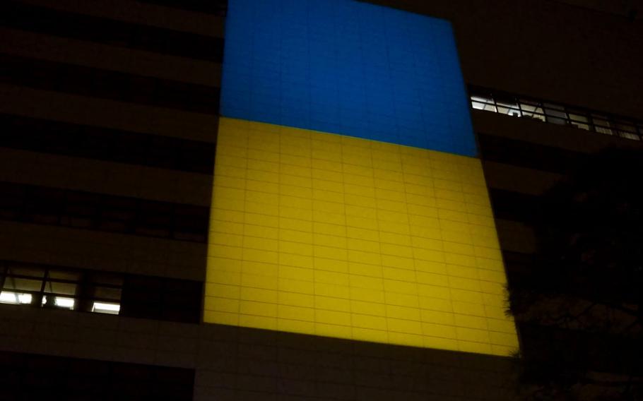The Ukraine flag is projected onto the U.S. Embassy in Tokyo, Wednesday, March 2, 2022. 