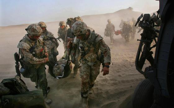Helmand province, Afghanistan, June 20, 2012: Danish troops carry a wounded soldier to an Air Force HH-60 Pave Hawk helicopter following an improvised explosive device attack in Helmand province, Afghanistan. 

META TAGS: Operation Enduring Freedom; Wars on Terror; Afghanistan; Danish Army; medevac; medical evacuation; IED;casualty; U.S. Air Force