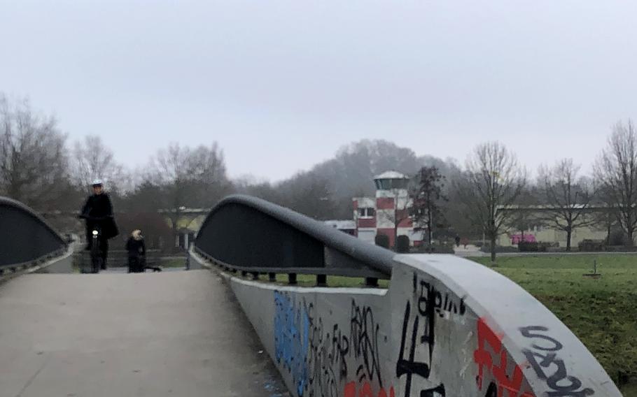 Cyclists and runners coming from Frankfurt cross the bridge over the Nidda River on Dec. 18, 2023, to a greenbelt on the site of a former American military base.
