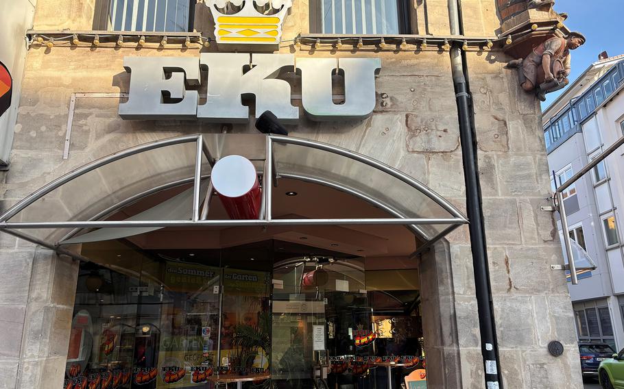 The exterior of the restaurant, adorned with a crown on top of “Eku” lettering. 