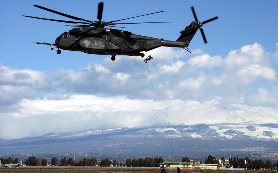 Sailors from Explosive Ordnance Disposal Mobile Unit 8 and HC-4 Squadron out of Naval Air Station Sigonella in Sicily practice rappelling from the back of a Navy CH-53 Super Stallion in 2007. The base, which has grown to support a variety of interservice missions, recently celebrated its 65th anniversary.