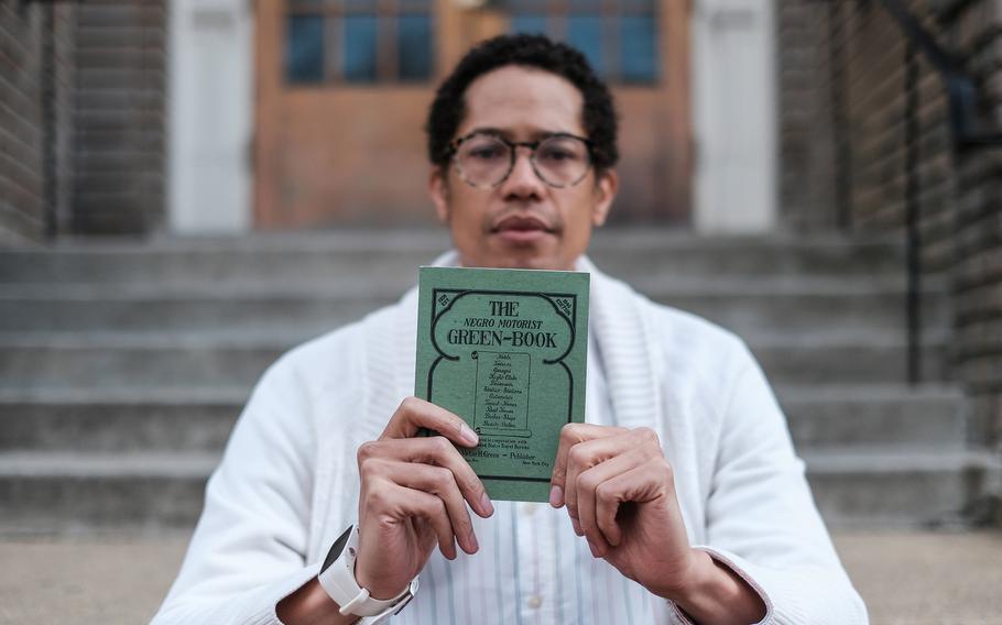 The writer holds a reprint of the 1940 Green Book. 