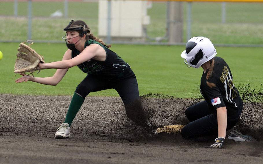 Kadena's Ava Sims slides in safely at second base ahead of the throw to Kubasaki shortstop Cadence Vandentop during Tuesday's Okinawa softball regular-season finale. The Panthers won 14-1, wrapping up an 8-0 regular season against the Dragons.