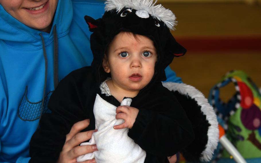 Myles Coedel, eight months, shows off his skunk costume during Halloween trick-or-treating at Tierra Vista Community housing at Schriever Air Force Base, Colo., Oct. 31, 2017. CDC Director Rochelle Walensky has encouraged Americans to get outside and relish the holiday this year.