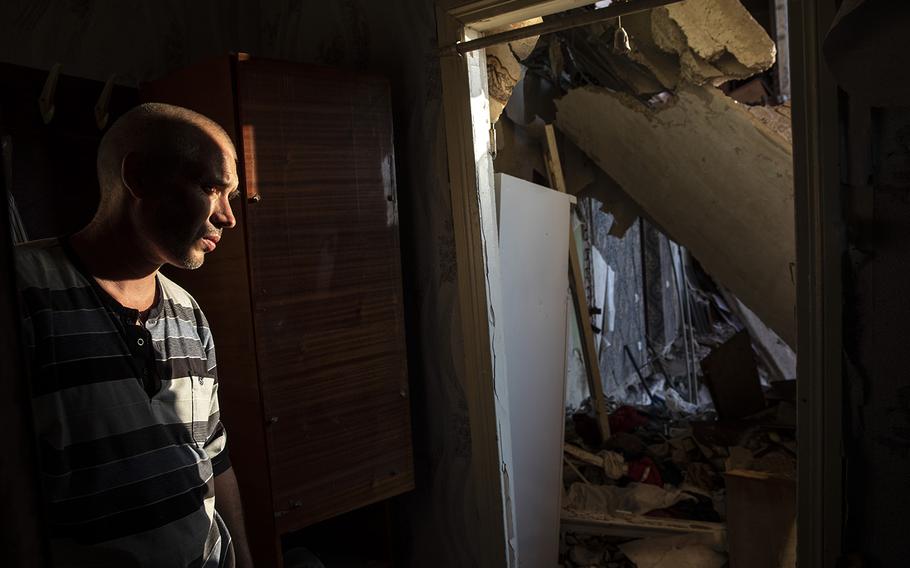 A resident surveys his damaged apartment in Bakhmut after it was hit by a Russian rocket. 