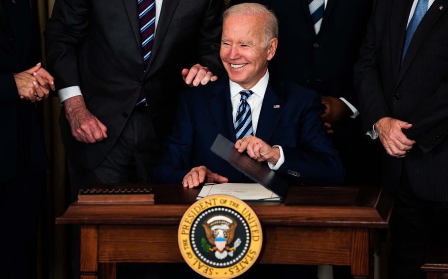 President Biden smiles after signing three bills in the State Dining Room at the White House on November 18, 2021.