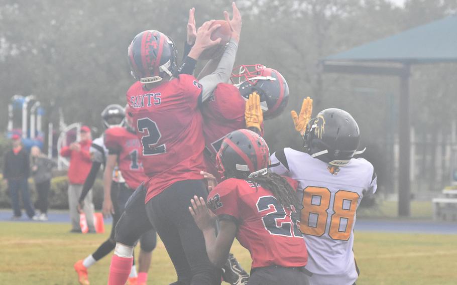 The ball is up for grabs Saturday, Oct. 22, 2022, in the Aviano Saints' 40-0 victory over the Vicenza Cougars. Aviano's Joshua Barthold came down with it.