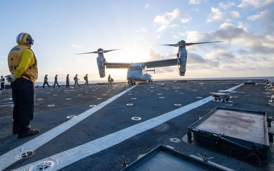 Sailors and Marines board an MV-22B Osprey on the flight deck of USS Germantown (LSD 42).