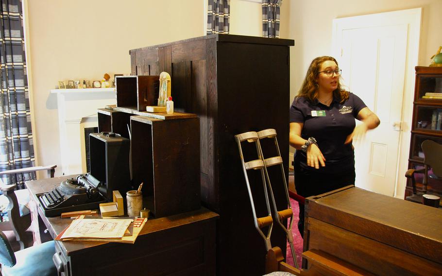 Student-docent Suzy Parker from Georgia College and State University points out many of the items remaining in the bedroom of Flannery O’Connor. The room doubled as a study, and O’Connor wrote much of her two novels and 32 short stories within its walls. 