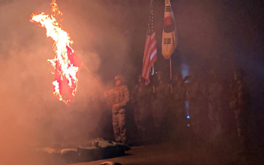 Soldiers of the 2nd Brigade Engineer Battalion burn their unit colors at Camp Casey, South Korea, Friday, Dec. 10, 2021. The annual ceremony reenacts the battalion’s actions during the Korean War in 1950.