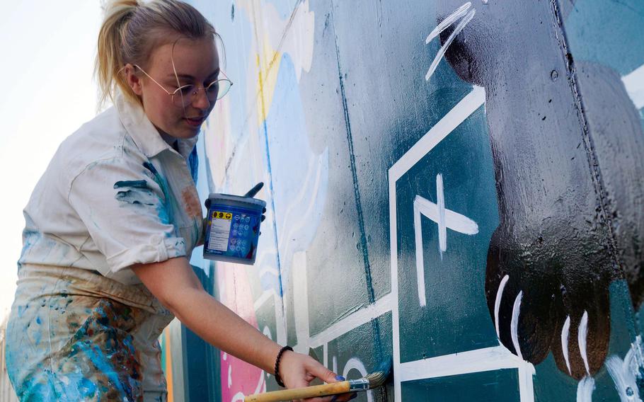 Artist Tenley Brady works on her mural at Osan Air Base, South Korea, Dec. 9, 2023. 