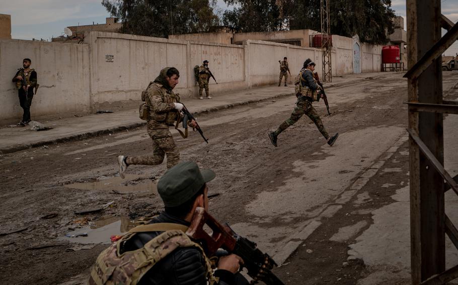 Fighters with the U.S.-backed Syrian Democratic Forces search house to house for ISIS militants and weapons in the Ghwaryan neighborhood of Hasakah, Syria, on Jan 31. 