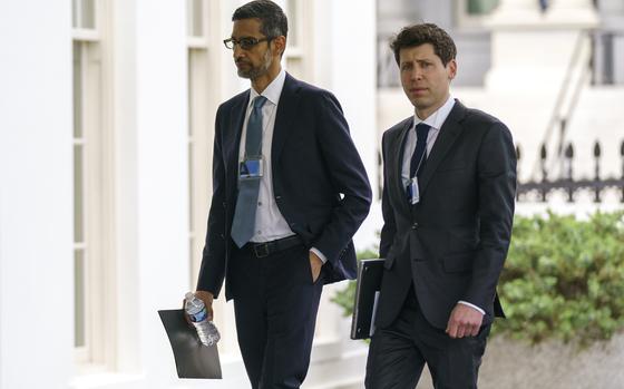 File - Alphabet CEO Sundar Pichai, left, and OpenAI CEO Sam Altman arrive to the White House for a meeting with Vice President Kamala Harris on artificial intelligence, Thursday, May 4, 2023, in Washington. As concerns grow over increasingly powerful artificial intelligence systems like ChatGPT, the nation's financial watchdog says it's working to ensure that companies follow the law when they're using AI. (AP Photo/Evan Vucci, File)