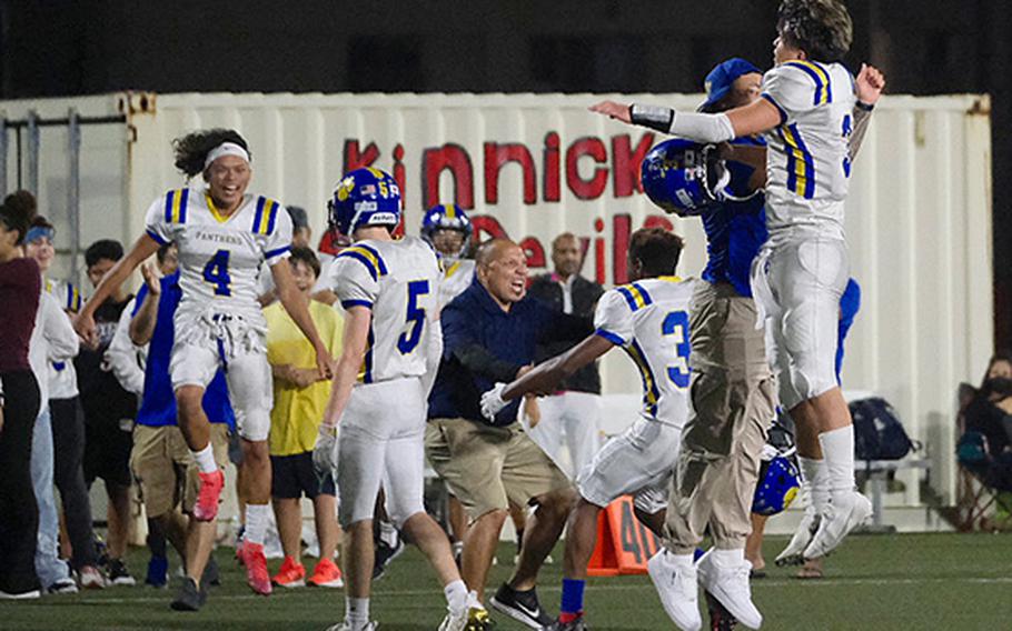 The Yokota Panthers celebrate on the sideline following their 21-20 road victory over the host Kinnick Red Devils on Friday, Sept. 30, 2022.