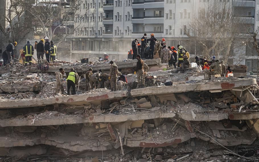 Rescue teams and members of the Turkish military look for earthquake survivors in Islahiye, Turkey, on Feb. 11, 2023. 