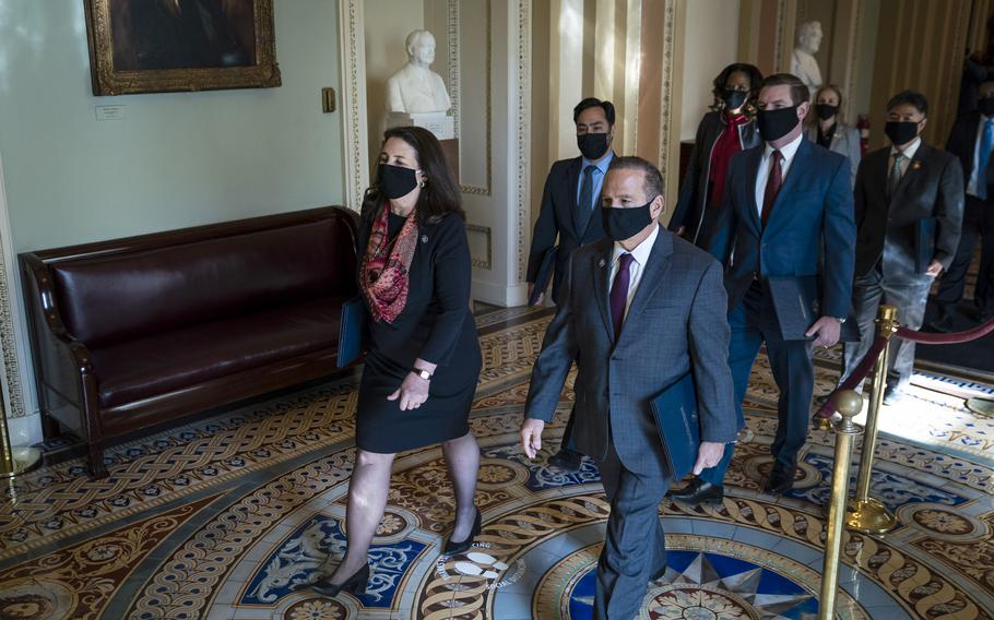 The House impeachment managers walk across to the Senate on the first day of the Senate impeachment trial on Capitol Hill on Feb 9, 2021. 
