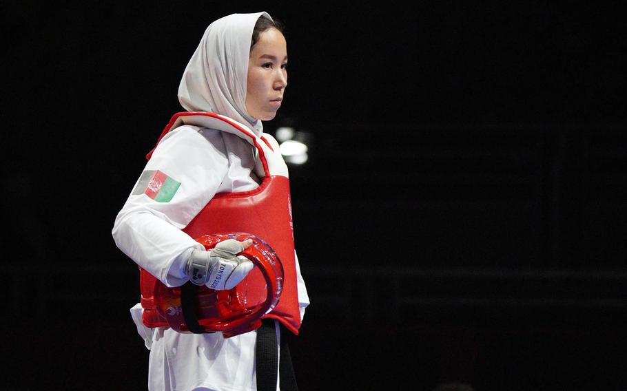 Afghan Taekwondo athlete Zakia Khudadadi, 22, enters the octagon to compete during the Tokyo Paralympics in Chiba prefecture, Japan, Thursday, Sept. 2, 2021. 