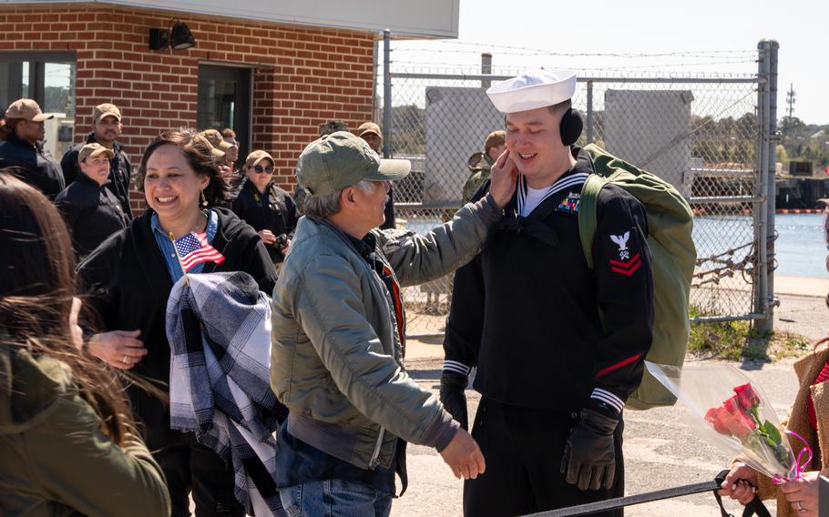 Logistics Specialist 2nd Class Tyler Smith, assigned to the Harpers Ferry-class dock landing ship USS Carter Hall (LSD 50), part of the Bataan Amphibious Ready Group (ARG), greets his family as the Carter Hall returns to Joint Expeditionary Base Little Creek-Fort Story, Thursday, March 21, 2024.