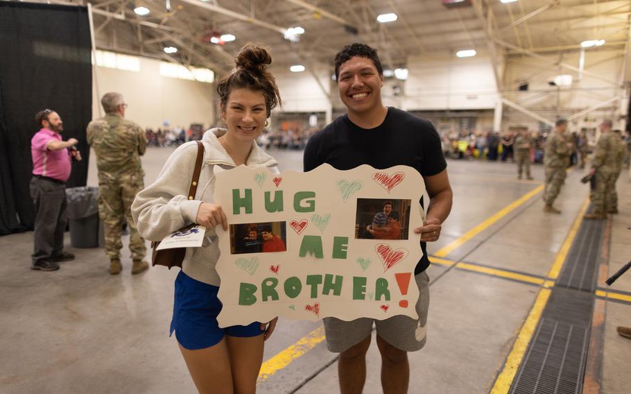 Family members of a Task Force Tomahawk soldier hold up a sign at the welcome home ceremony at Will Rogers Air National Guard Base in Oklahoma City, Feb. 24, 2024. 