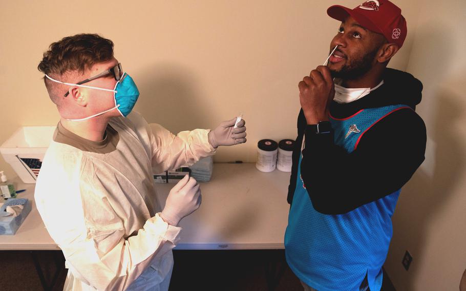 Airmen from the 51st Operational Medical Readiness Squadron demonstrate how to properly swab the nose for an COVID-19 antigen test at Osan Air Base, South Korea, on Jan. 7, 2022.