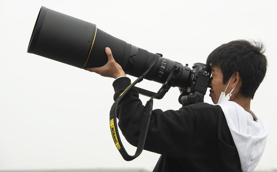 Masafumi Mizuoka, a college student from Osaka, photographs aircraft taking off from Marine Corps Air Station Iwakuni, Japan, April 19, 2023. 