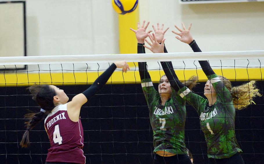 Seisen's Maya Hemmi spikes against Kubasaki's Grace Berrens and Emma Leggio.