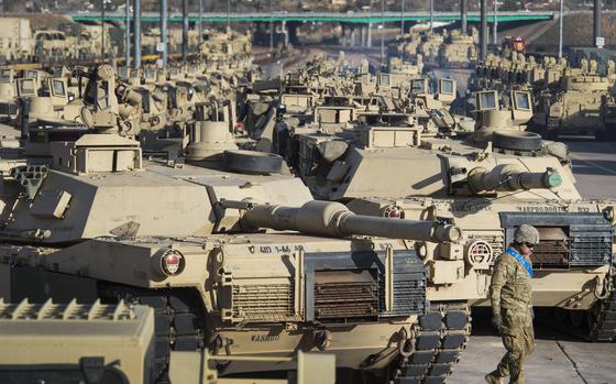 FILE - A soldier walks past a line of M1 Abrams tanks, Nov. 29, 2016, at Fort Carson in Colorado Springs, Colo.  In what would be a reversal, the Biden administration is poised to approve sending M1 Abrams tanks to Ukraine, U.S. officials said Tuesday, as international reluctance toward sending tanks to the battlefront against the Russians begins to erode. The decision could be announced as soon as Wednesday though it could take months or years for the tanks to be delivered.  (Christian Murdock/The Gazette via AP, File)