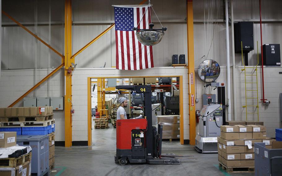 A worker operates a forklift at a manufacturing facility in Virginia Beach, Va.