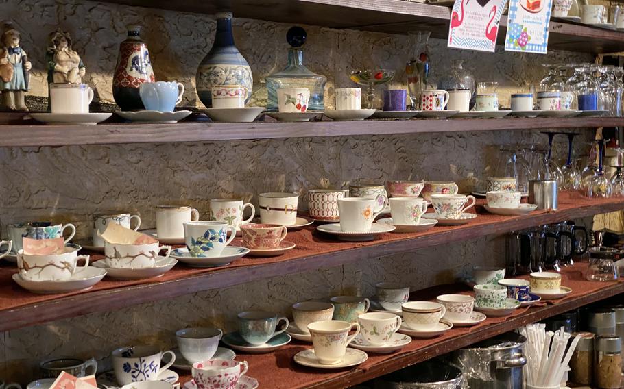 Shelves overflowing with antique cups and brass pots harken back to a time gone by at Tajimaya Coffee House in Tokyo. 