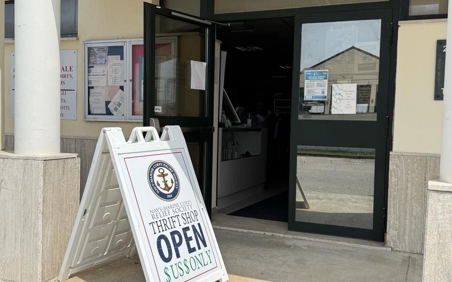 A sign says the thrift shop is open.