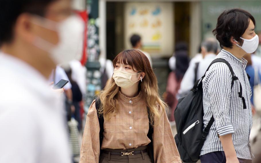 People walk outside Shibuya Station in central Tokyo, Wednesday, Sept. 8, 2021. Tokyo prefecture recorded 1,834 COVID-19 infections that day. 