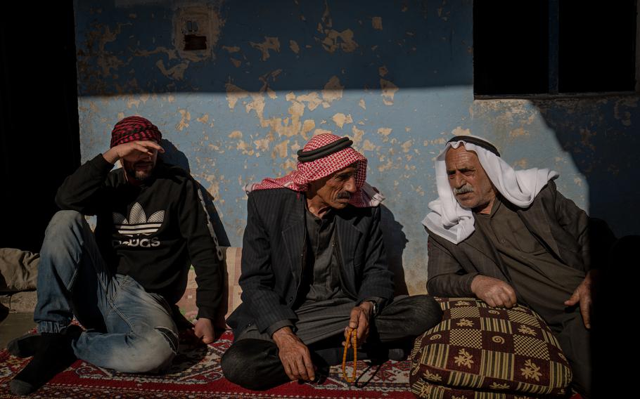 Khalifa Salim al-Jeddal, center, a farmer, is seen at home in the village of Jallo in northeastern Syria on Feb. 6, 2022. 