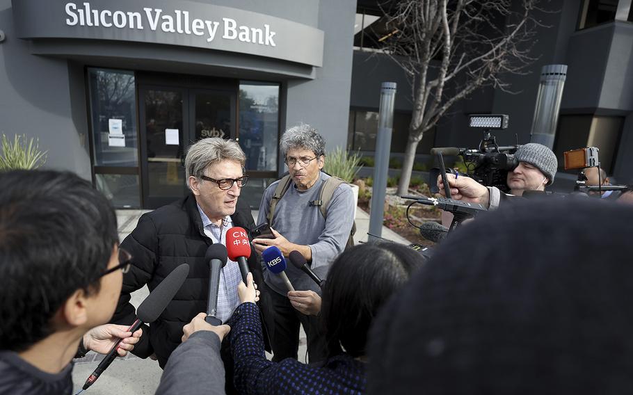 A Silicon Valley Bank customer answers questions outside of the bank office on March 13, 2023, in Santa Clara, California.