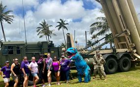 Visitors to the Fun in the Field event at Andersen Air Force Base, Guam, pose by a Terminal High Altitude Area Defense, or THAAD, launcher on April 23, 2022.