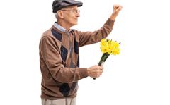 Senior holding flowers and preparing to knock on a door isolated on white background