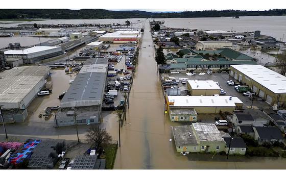 This aerial view shows a flooded neighborhood in Pajaro, California, on March 13, 2023. Houses were inundated and vehicles submerged when the Pajaro River burst over a crumbling levee overnight Friday into Saturday. (Jennifer Cain/AFP/Getty Images/TNS)