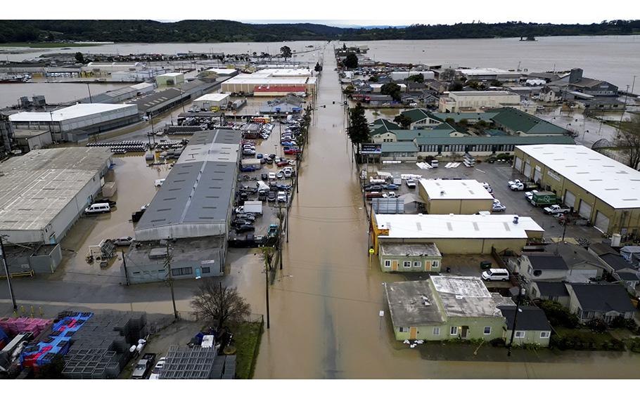This aerial view shows a flooded neighborhood in Pajaro, California, on March 13, 2023. Houses were inundated and vehicles submerged when the Pajaro River burst over a crumbling levee.