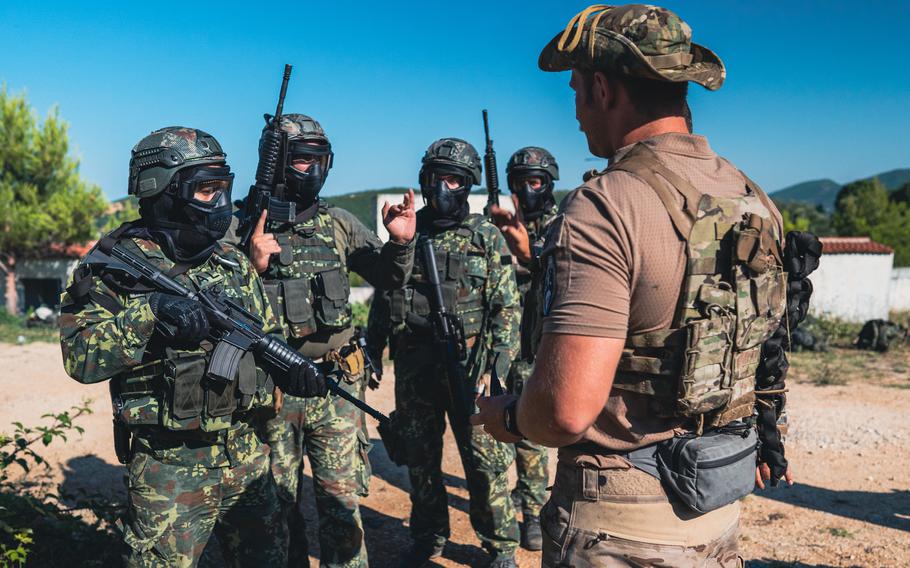 A U.S. Army Green Beret  prepares Albanian special forces soldiers for drills July 23, 2021. The Stuttgart, Germany-based U.S. Special Operations Command Europe said Thursday that it has positioned a new forward operating headquarters in Albania.