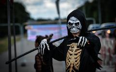 An activist plays the roll of death during a "Dance of the Dead" protest against war in Ramstein-Miesenbach, Germany, June 25, 2022. Protestors wore skeleton costums and skull masks to call attention the affects of the weapons manufacture and military industry.