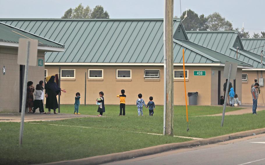 Evacuees hang out outside Operation Allies Welcome barracks Thursday, Oct. 14, 2021, at Camp Atterbury in Edinburgh, Ind.