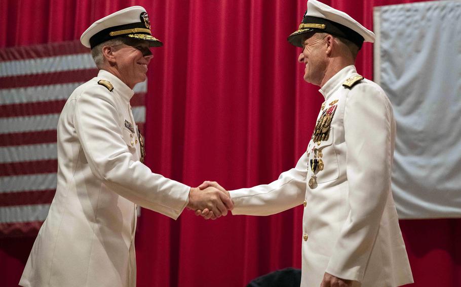 Vice Adm. Karl Thomas, left, greets Vice Adm. Bill Merz during a change-of-command ceremony for 7th Fleet at Yokosuka Naval Base, Japan, Thursday, July 8, 2021. 